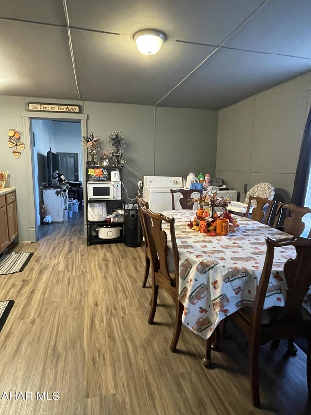 dining room with wood-type flooring and washer / dryer