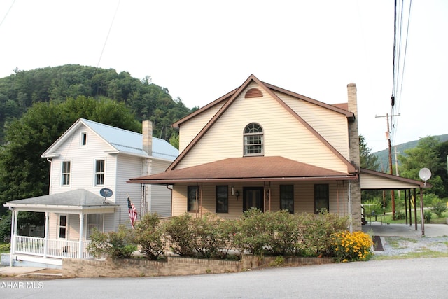 view of front of home featuring a porch and a carport