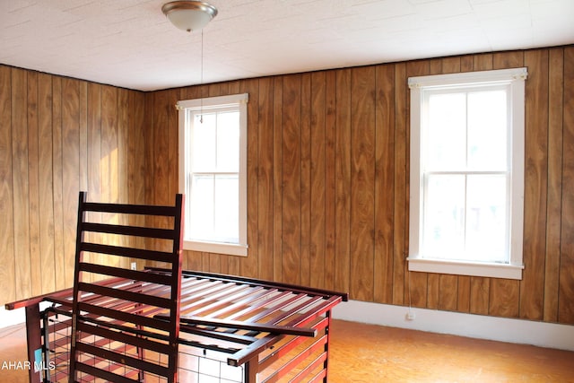 carpeted bedroom with wooden walls