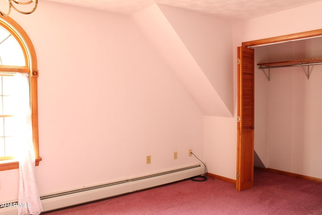 unfurnished bedroom featuring light carpet, a baseboard radiator, a closet, and lofted ceiling