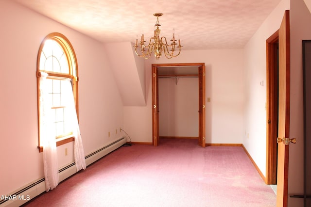 carpeted spare room featuring vaulted ceiling, a textured ceiling, a baseboard heating unit, and a notable chandelier