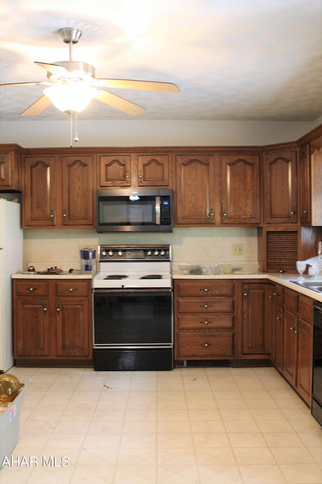 kitchen featuring white appliances and ceiling fan