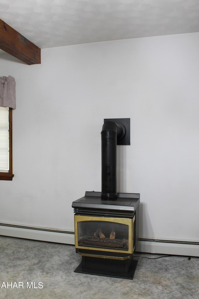 details with carpet, beam ceiling, a wood stove, and a baseboard heating unit