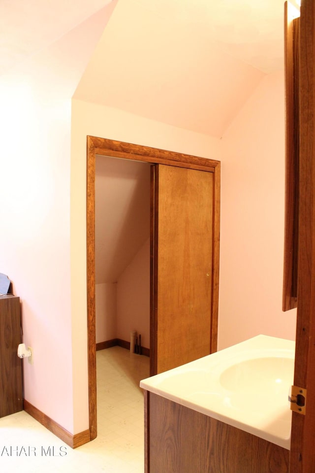 bathroom with vanity and vaulted ceiling