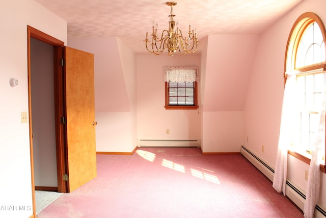 unfurnished room featuring a baseboard heating unit, a chandelier, a textured ceiling, lofted ceiling, and light carpet