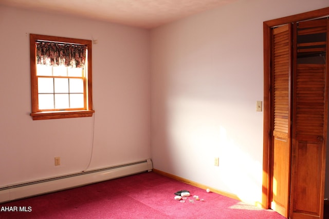 carpeted empty room with baseboard heating