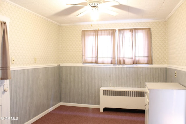 unfurnished bedroom with ceiling fan, radiator heating unit, ornamental molding, and carpet floors