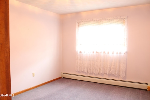 empty room featuring light carpet and a baseboard radiator