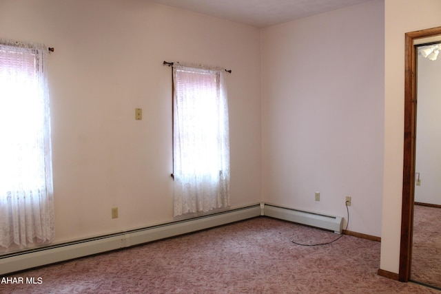 unfurnished room featuring light colored carpet and a baseboard radiator