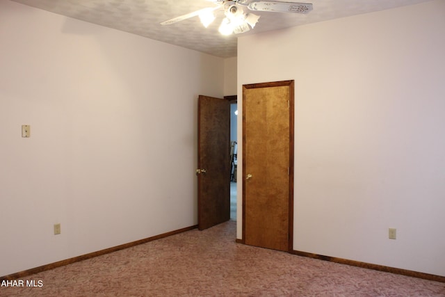 carpeted spare room with ceiling fan and a textured ceiling