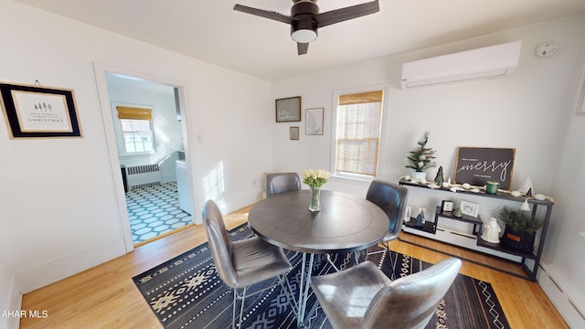 dining room with radiator, ceiling fan, wood-type flooring, a baseboard radiator, and an AC wall unit