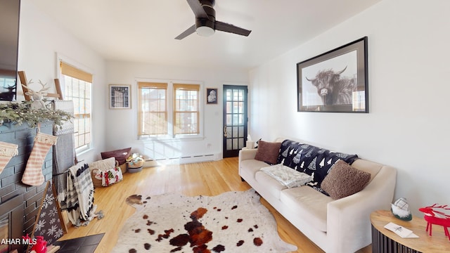 living room with hardwood / wood-style flooring, ceiling fan, and a healthy amount of sunlight