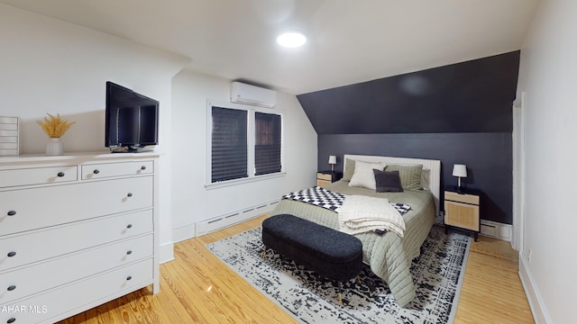 bedroom featuring vaulted ceiling, light wood-type flooring, baseboard heating, and an AC wall unit