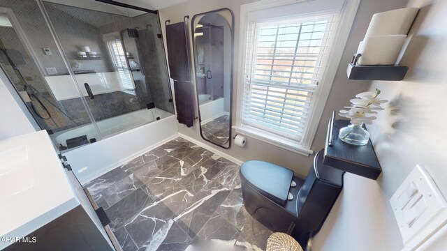 bathroom with shower / bath combination with glass door