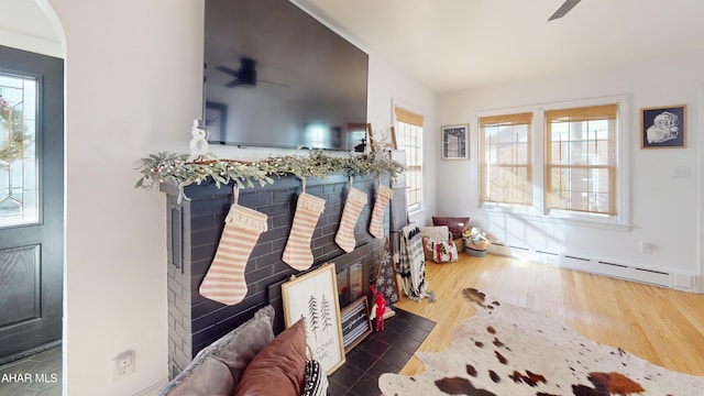 interior space with a wealth of natural light, ceiling fan, and dark hardwood / wood-style floors