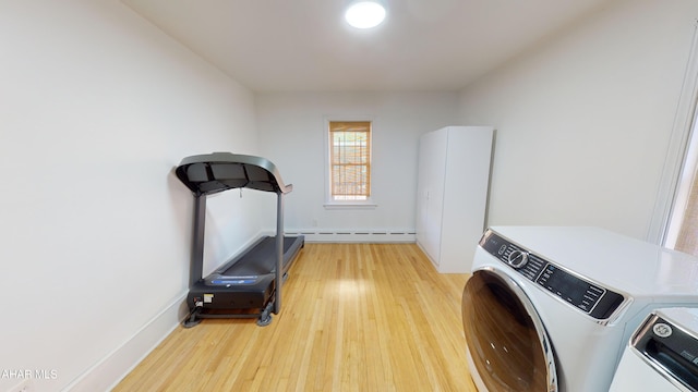 laundry room with hardwood / wood-style flooring, separate washer and dryer, and baseboard heating