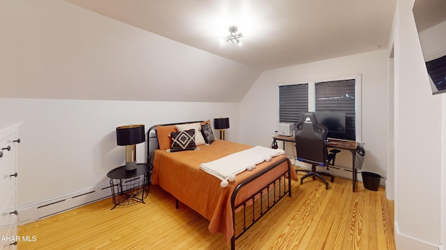 bedroom featuring light hardwood / wood-style floors, vaulted ceiling, and baseboard heating