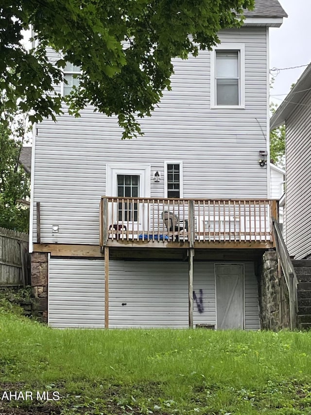 rear view of property featuring a deck