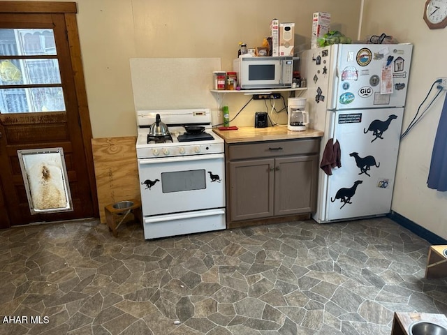 kitchen featuring white appliances, gray cabinets, and ornamental molding