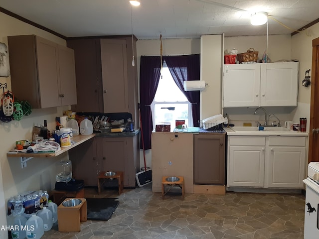 kitchen featuring white cabinetry, electric range, sink, and pendant lighting