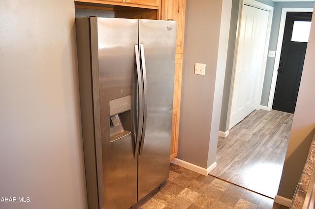 kitchen with stainless steel fridge with ice dispenser and wood-type flooring