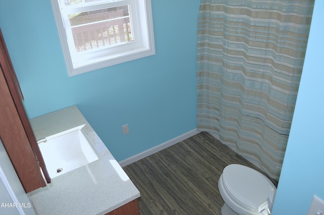 bathroom with hardwood / wood-style floors, vanity, and toilet