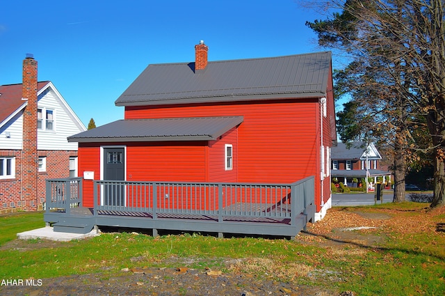 rear view of house featuring a deck