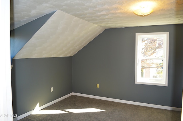 bonus room with carpet, a wealth of natural light, and lofted ceiling