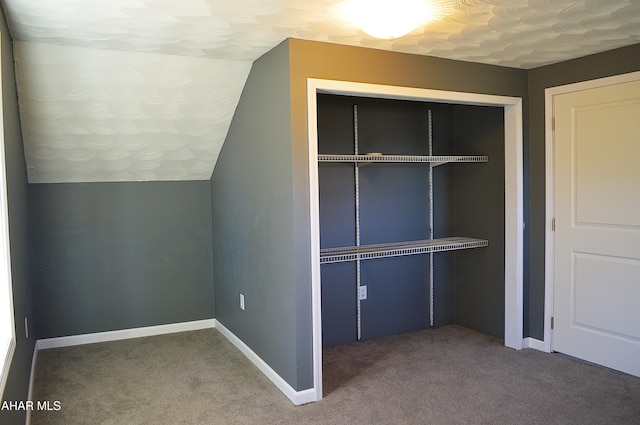 interior space featuring carpet and lofted ceiling