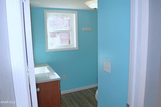 bathroom featuring hardwood / wood-style floors, vanity, and toilet