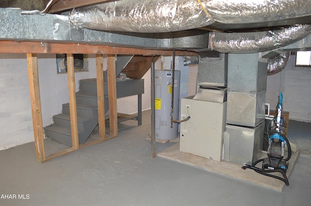 basement featuring heating unit and water heater