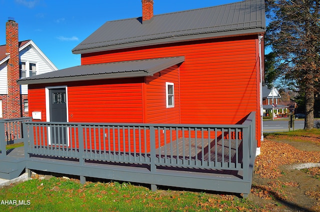 rear view of house featuring a deck