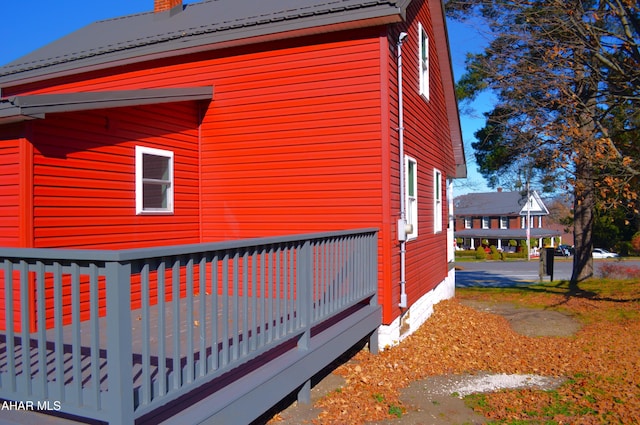 view of home's exterior featuring a wooden deck