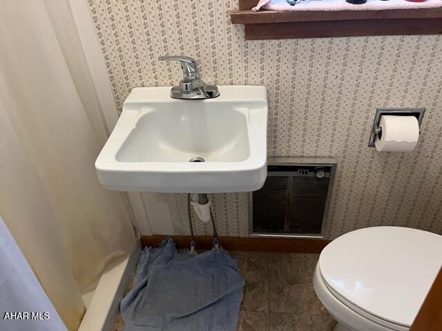 bathroom with sink, tile patterned flooring, and toilet