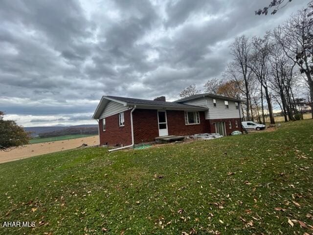 view of side of home featuring a lawn