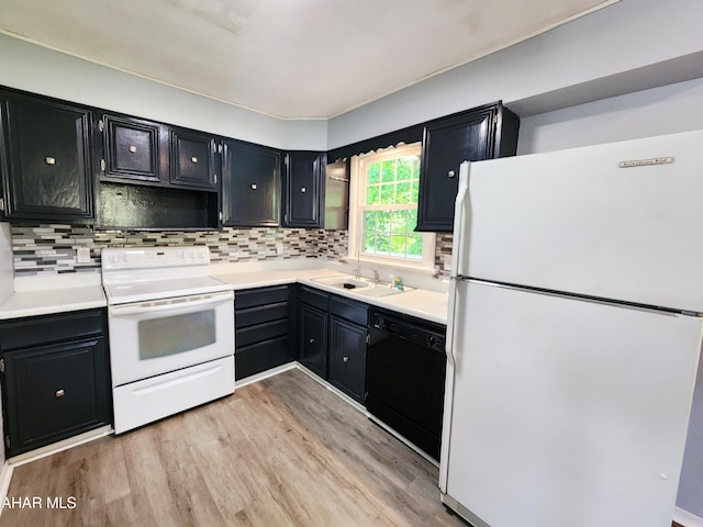 774 Hench St, Bedford, PA 15522 - kitchen with black appliances, dark cabinetry, light wood-style floors, a sink, and decorative backsplash