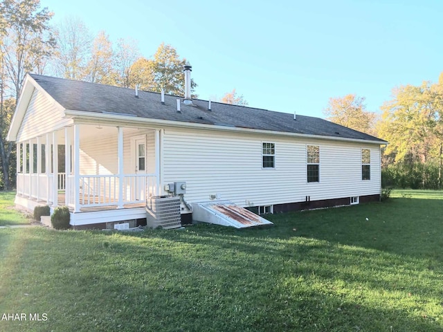 rear view of property with a yard