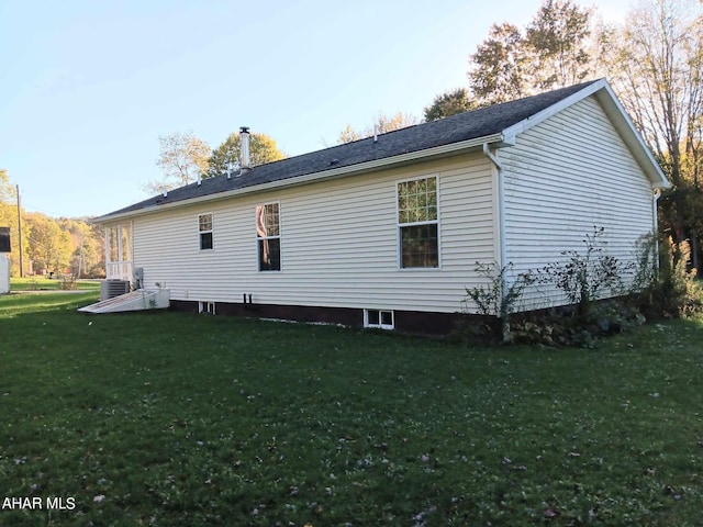 view of property exterior with central air condition unit and a lawn