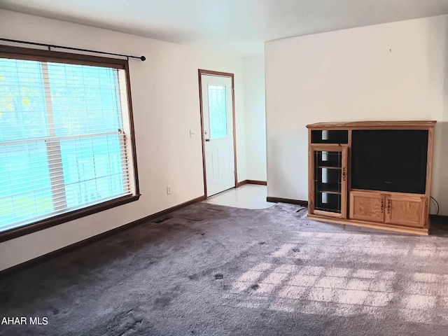 unfurnished living room with light colored carpet