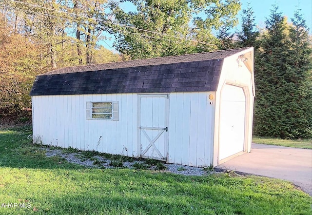 view of outbuilding with a lawn