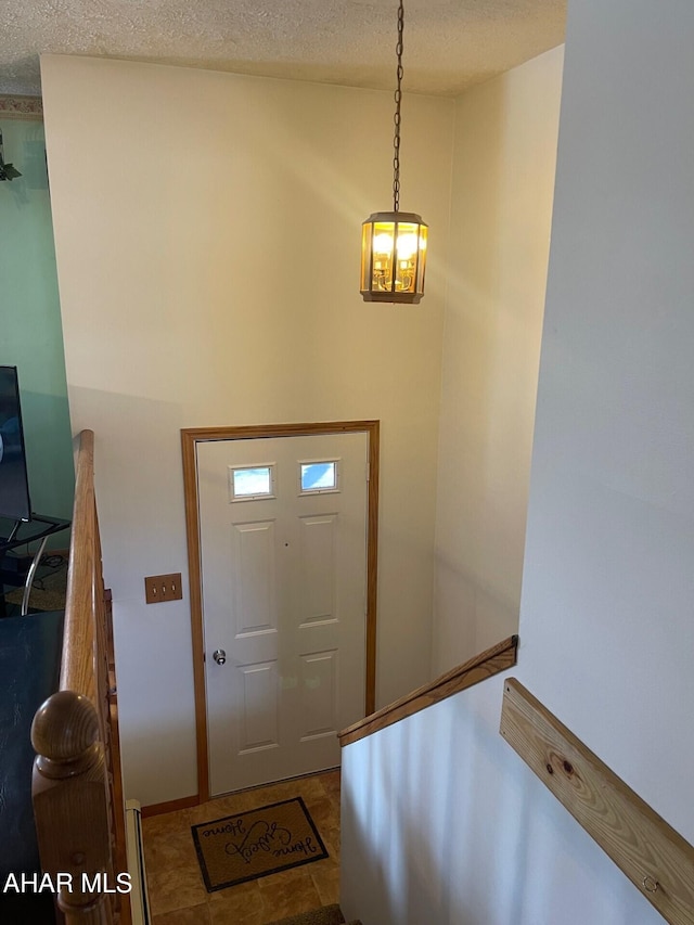 foyer with a textured ceiling