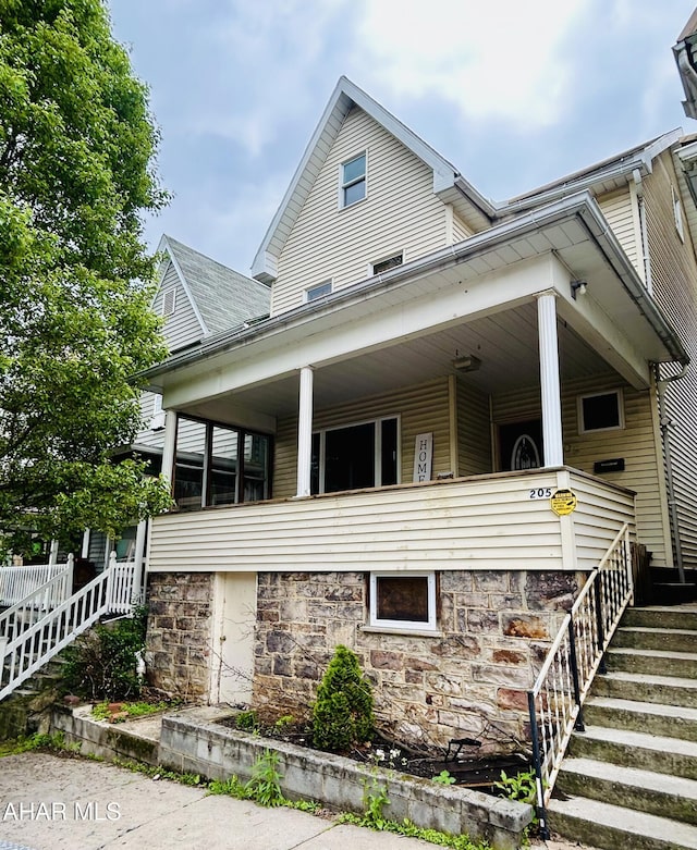 205 1st Ave, Altoona, PA 16602 - view of front of property with stairway, covered porch, and stone siding
