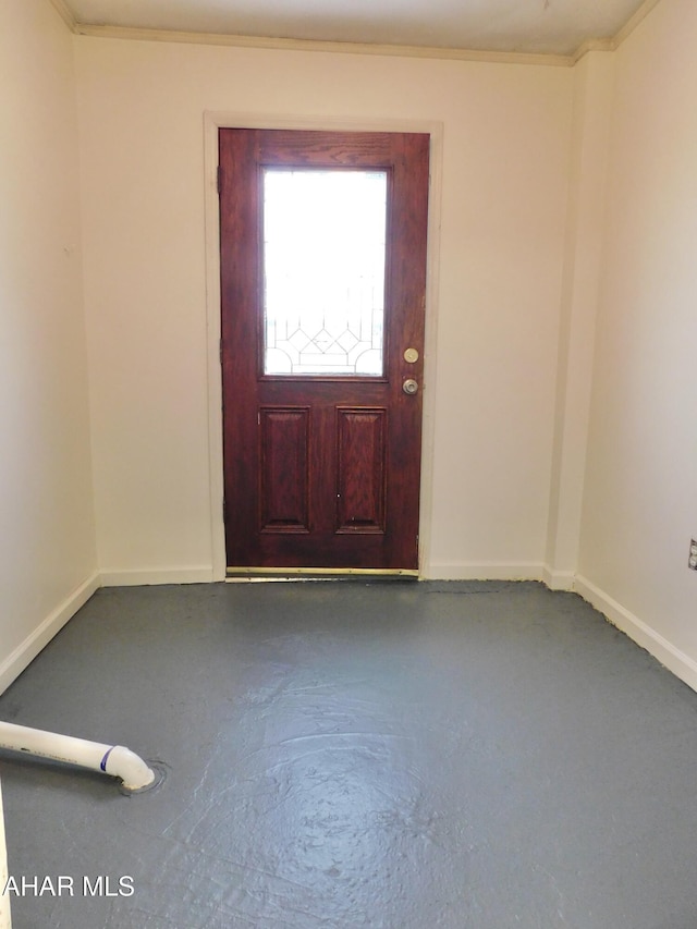 entrance foyer featuring concrete flooring and ornamental molding