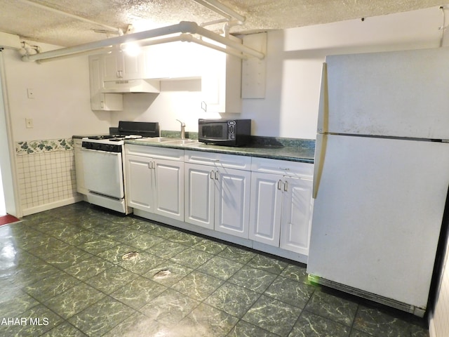 kitchen with sink, white appliances, a textured ceiling, and white cabinets