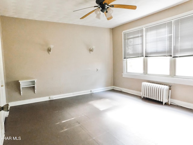 empty room featuring radiator heating unit and ceiling fan