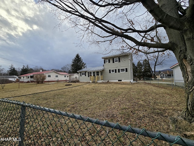 view of front facade with a fenced backyard and a front lawn