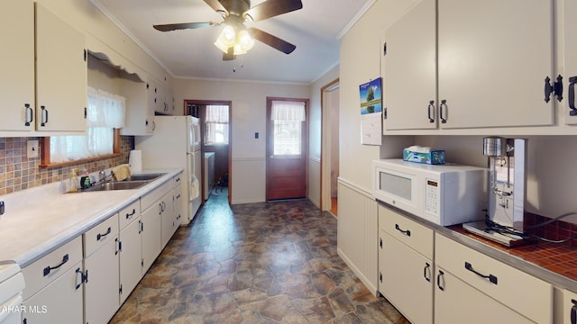 2414 4th Ave, Altoona, PA 16602 - kitchen featuring white appliances, crown molding, stone finish flooring, white cabinets, and tasteful backsplash
