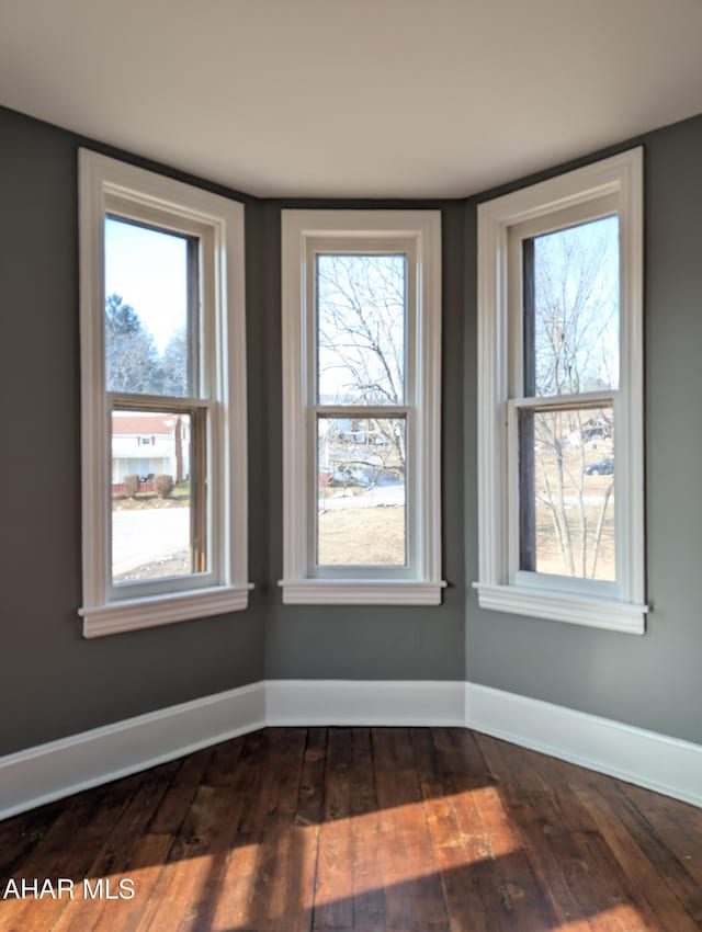 spare room with dark hardwood / wood-style flooring