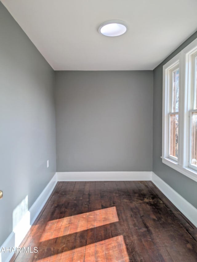 empty room with dark hardwood / wood-style floors