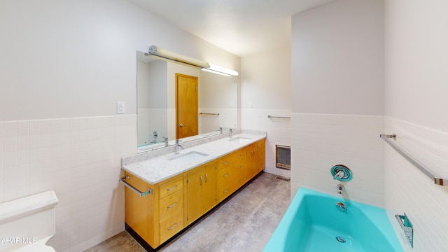 79 Mill Rd, Duncansville, PA 16635 - bathroom featuring tile walls, double vanity, wainscoting, and a garden tub